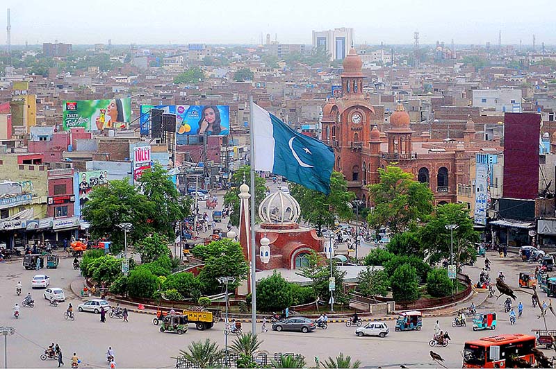 A view of the Clock Tower Chowk, with its bustling traffic and vibrant surroundings