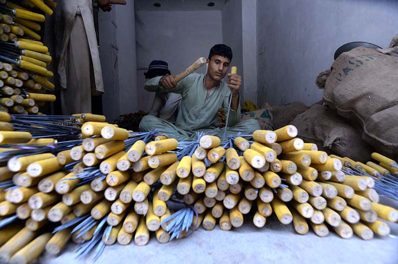 A vendor arranging and selling iron skewers and barbecue stoves ahead of Eid ul Azha at Reti bazaar