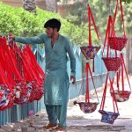 A vendor displaying swings for children to attract customers at his roadside setup