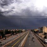 After the rain in the city, a captivating sight unfolds as dark clouds hover over the sky, creating a dramatic and alluring atmosphere