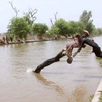Children diving in canal to get relief from the scorching hot weather in the city