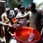 Volunteers are distributing sweet water among the people during hot weather in the city