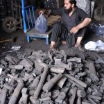 June 25 – A vendor selling coal to attract customers at his workplace for upcoming Eid ul-Azha