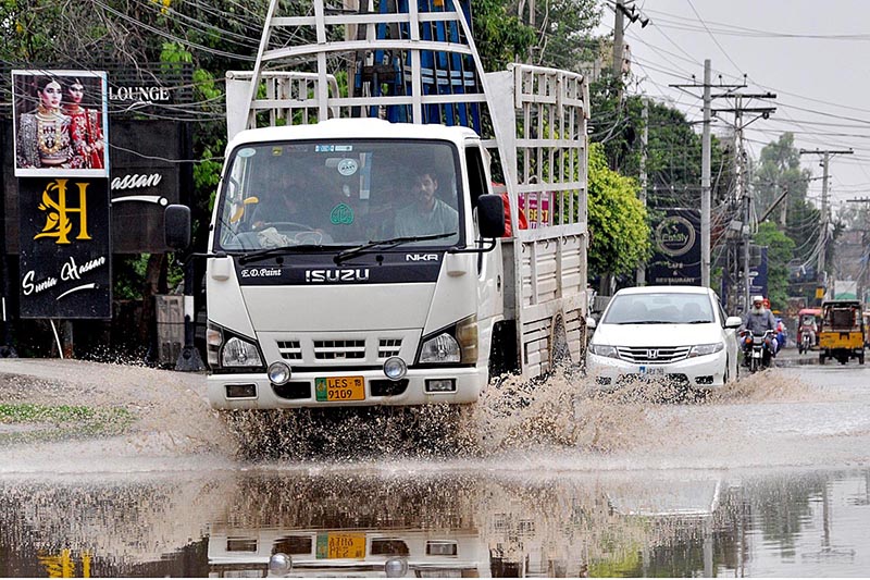 Woman riding a motorcycle along with a boy at College Road