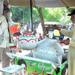 A vendor selling traditional summer drink (Lasi) at his roadside setup