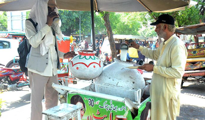 A vendor selling traditional summer drink (Lasi) at his roadside setup