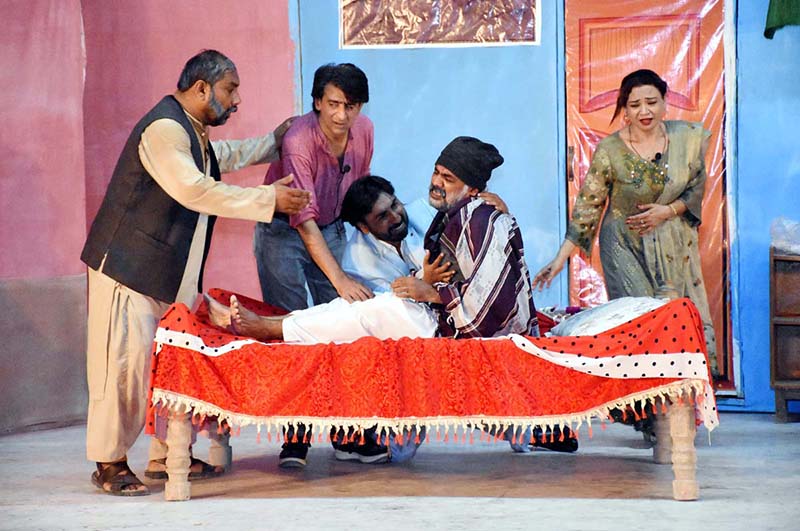 Artists performing in stage drama " Morakh Unj Maran " during Sindh Theatre Festival 2023 at ZA Bhutto Open Air Theater