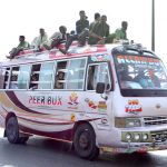 People traveling on rooftop of passenger bus at Tando Jam Road may cause any mishap and needs the attention of concerned authorities
