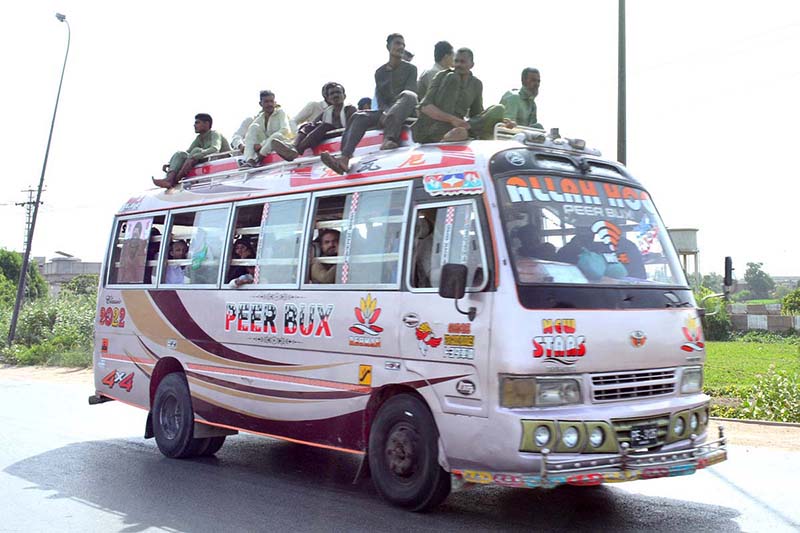 People traveling on rooftop of passenger bus at Tando Jam Road may cause any mishap and needs the attention of concerned authorities