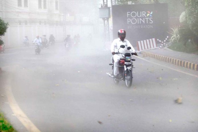 Motorcyclists strugling to move during a wind strom in the city Motorcyclists strugling to move during a wind strom in the city