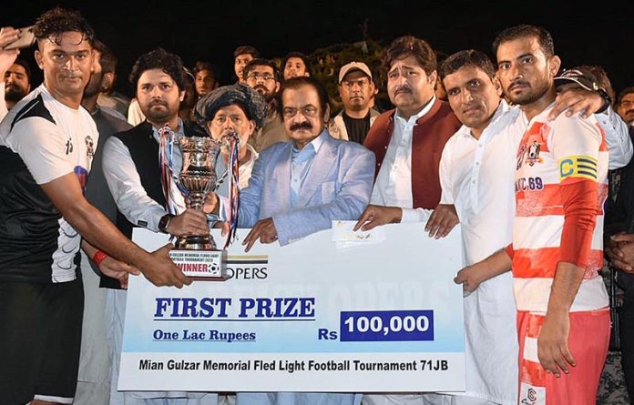 Interior Minister Rana Sana Ullah Khan giving away trophy to the players of the winning Football Team during Mian Gulzar Memorial Fled Light Football Tournament-71 JB