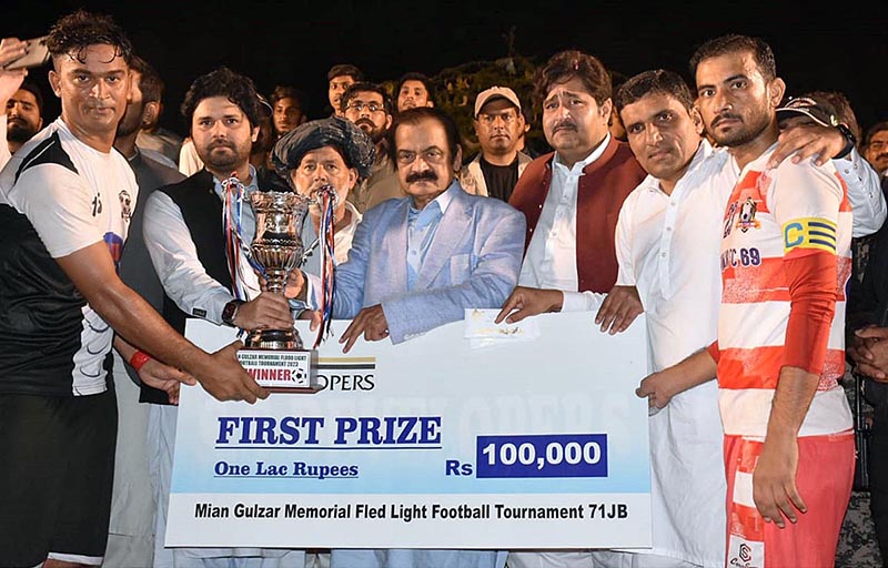Interior Minister Rana Sana Ullah Khan giving away trophy to the players of the winning Football Team during Mian Gulzar Memorial Fled Light Football Tournament-71 JB