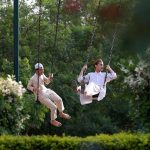 Boys enjoying swing at a local park at F/6/1 sector