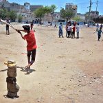 Children playing cricket in a local ground at Korangi area