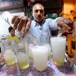 A street vender selling lemon soda water during hot day in the city
