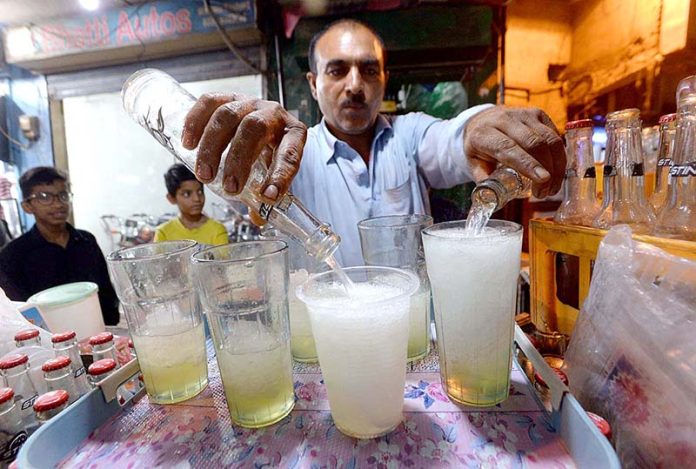A street vender selling lemon soda water during hot day in the city