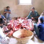 Butchers cutting sacrificial animal meat after slaughtering on the 2nd day of Eid ul Adha