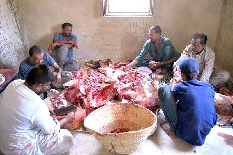 Butchers cutting sacrificial animal meat after slaughtering on the 2nd day of Eid ul Adha