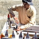 A vendor busy in preparing qulfi at his road side setup to attract customers