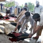Butchers busy in slaughtering sacrificial animals at Midrasa Zia ul Aloom, Satellite Town, E-Block on the occasion of Eidul Azha
