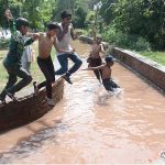 Youngsters jumping into water to get some relief from hot weather