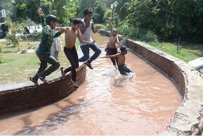 Youngsters jumping into water to get some relief from hot weather