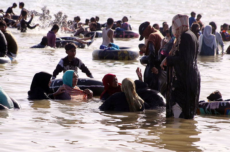 Large number of people enjoying bathing in Keenjhar lake people come here for picnics during the summer school holidays to get relief from hot weather