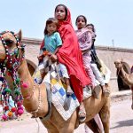 Children enjoying camel ride during the 1st day of Eid Ul Azha near Railway Station