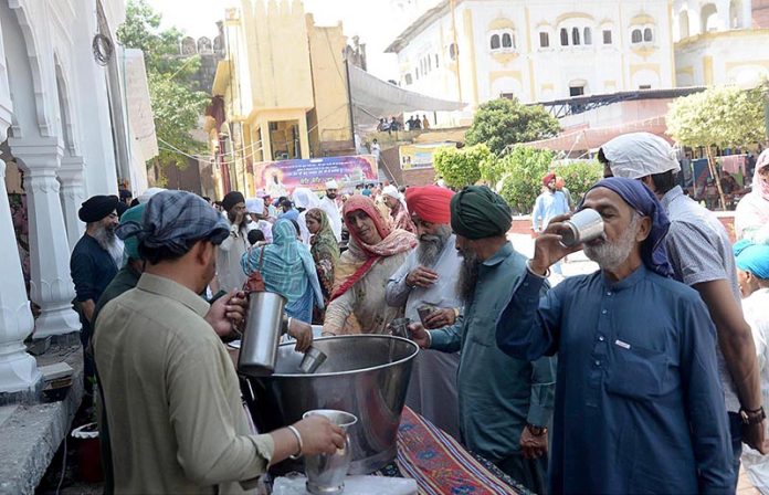 People are drinking water during main ceremony-Bhog Akhand Paatg Sahib to observe Martyrdom Day of Guru Arjun Dev Jee at Gurdawara Dera Sahib