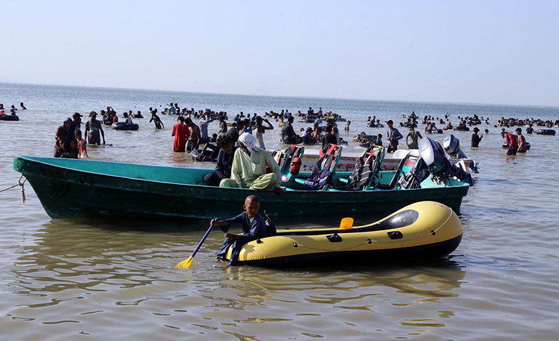Large number of people enjoying bathing in Keenjhar lake people come here for picnics during the summer school holidays to get relief from hot weather