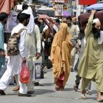People with their luggage arrives at Faizabad Bus Stand to leave for their hometowns to celebrate Eid ul Azha with their loved ones