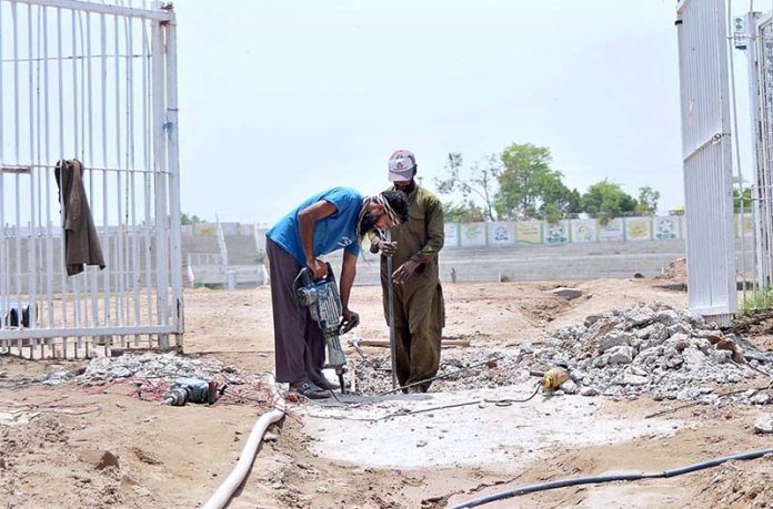 Labourers are busy in digging during development work at the historical Qasim Fort Stadium