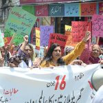 Women participates in a walk rally outside the Press Club to mark the International Day of Domestic workers