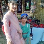Young girls wearing traditional Kashmiri caps and posing for photograph during Saqafati Mela promoting Pakistani culture providing entertainment to public at Lok Virsa