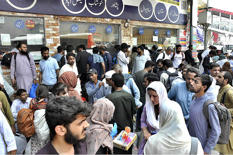People with their luggage arrives at Faizabad Bus Stand to leave for their hometowns to celebrate Eid ul Azha with their loved ones