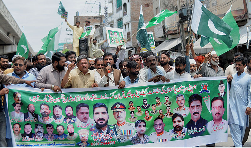 People participating in a walk-in rally to express their solidarity with the Pak army organized by Pasban Rickshaw Taxi Driver Union Register Punjab at Chowk Aziz