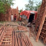Workers busy in preparing ladder with bamboos at his workplace