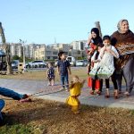 Family enjoying monkey spectacle at local Park