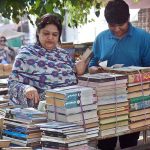 People busy in selecting and purchasing old books from roadside setup in Provincial Capital