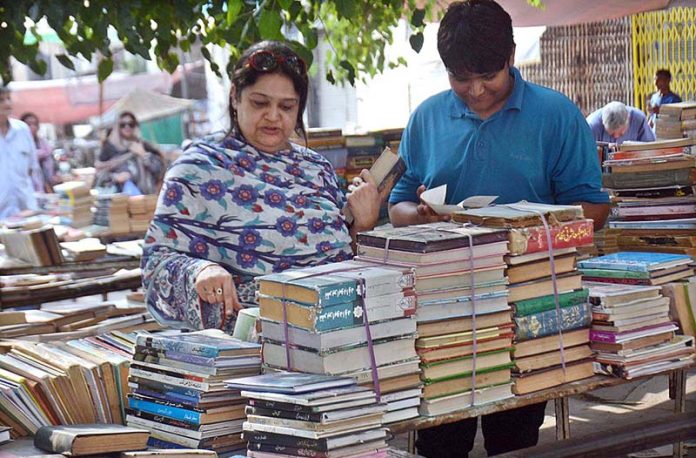 People busy in selecting and purchasing old books from roadside setup in Provincial Capital
