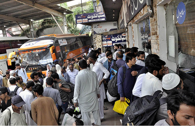 People with their luggage arrives at Faizabad Bus Stand to leave for their hometowns to celebrate Eid ul Azha with their loved ones