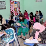 Female students giving a pre-entry test for admission 11th class of science group at County Girls Collage