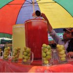 A vendor selling traditional summer drink at his roadside setup