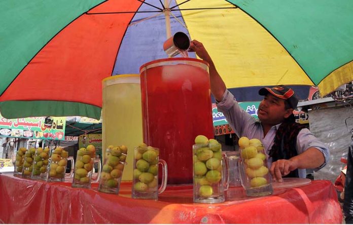 A vendor selling traditional summer drink at his roadside setup