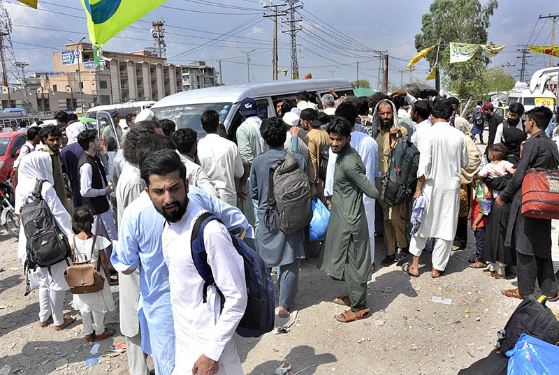 People with their luggage arrives at Faizabad Bus Stand to leave for their hometowns to celebrate Eid ul Azha with their loved ones
