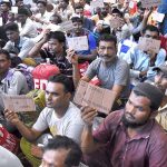 Indian fishermen show their identity cards at Lahore Railway Station after Pakistan authorities released them, allegedly arrested for trespassing into its territorial waters
