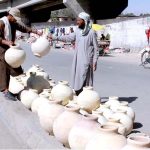 Vendor decorating pithos (matka) for customers which demands increased in hot weather at Joint Road