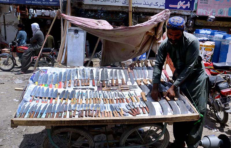 A vendor displaying knifes on his cart on the occurrence of Eid-ul Azha
