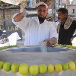 A vendor preparing a traditional summer drink (Shikanjabeen) to attract the customers at Ghanta Ghar Chowk