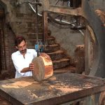 A worker busy in cutting wood in pieces to be used by butchers to cut meat of sacrificial animals on the occason of Eid ul-Azha